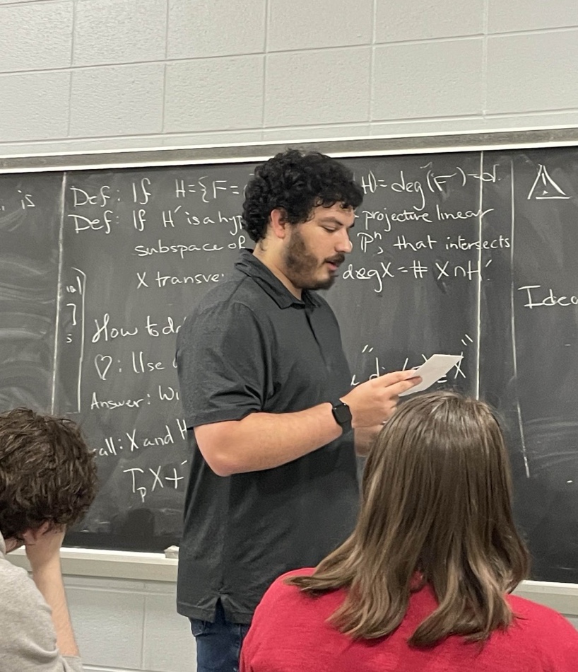 Teaching in front of a Chalkboard